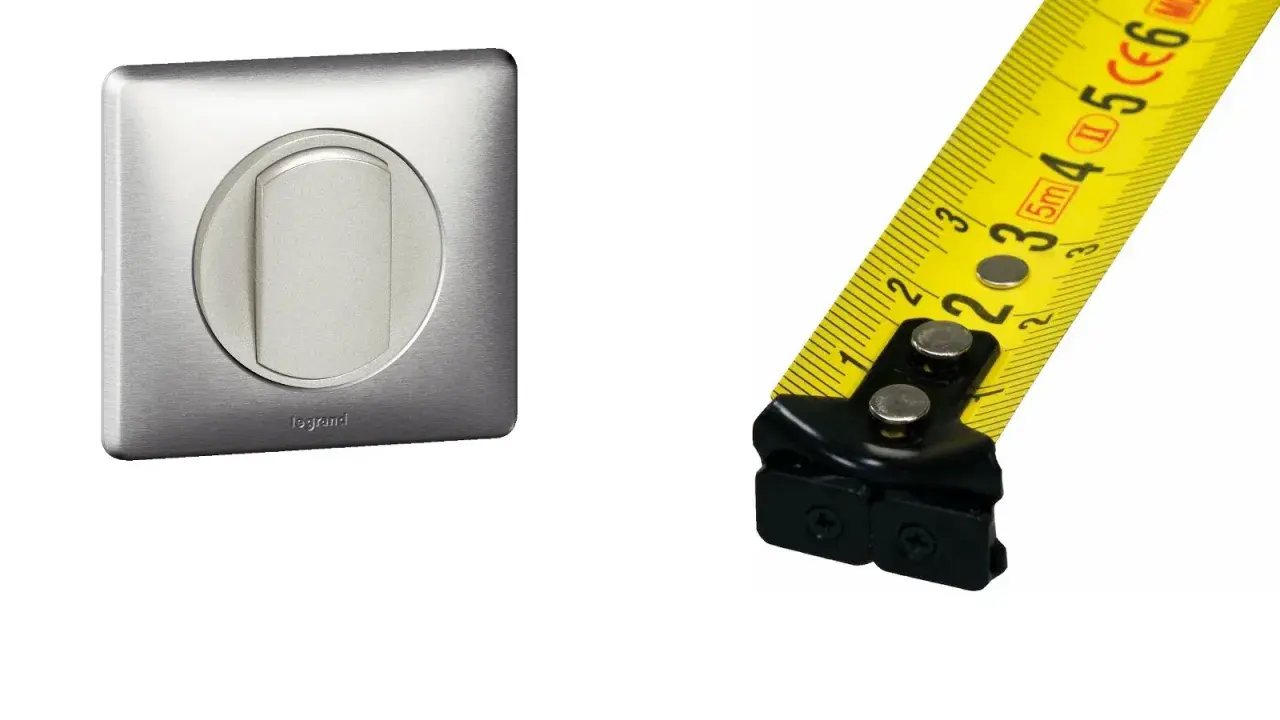 Interrupteur Legrand en métal brossé et mètre ruban jaune. Mesure de la hauteur interrupteur.