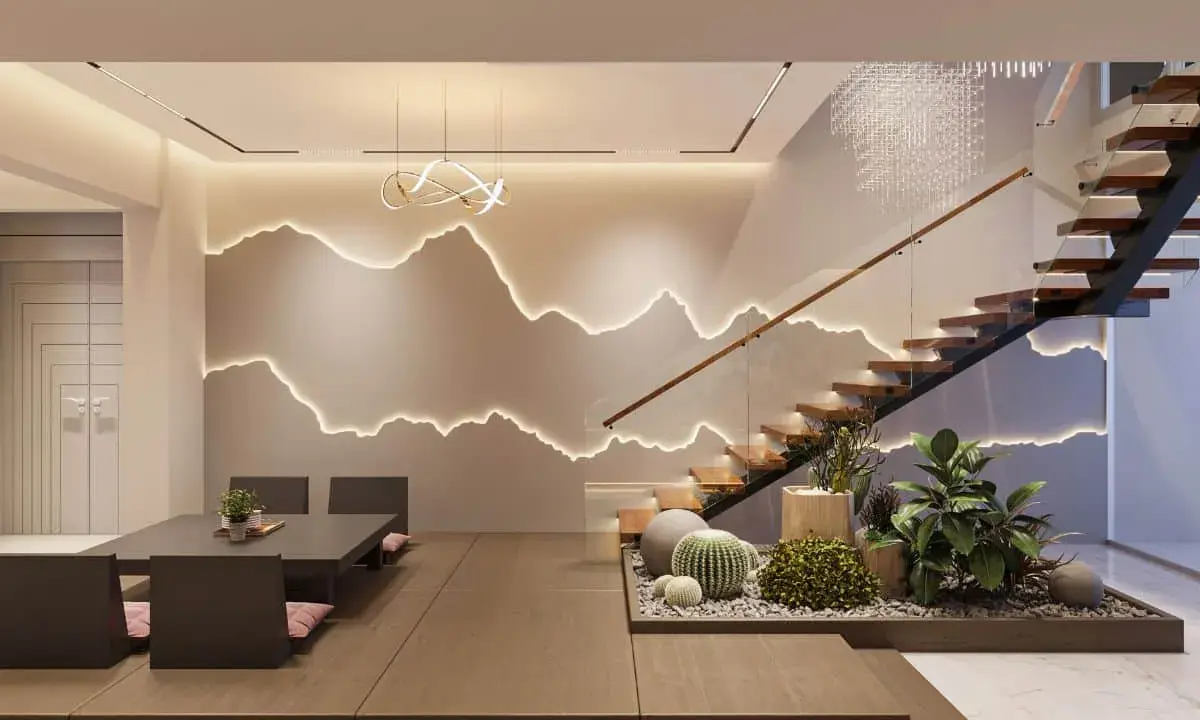 Intérieur moderne avec escalier en bois, éclairage mural en forme de montagnes et mobilier épuré.