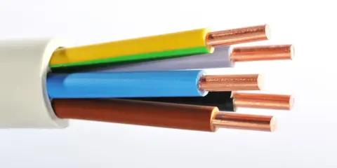 Gros plan sur un type de câble électrique avec des fils de cuivre dénudés de différentes couleurs : jaune, vert, gris, bleu, noir et marron.
